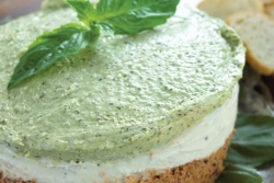 Tri color cheese torta with green garnish on top